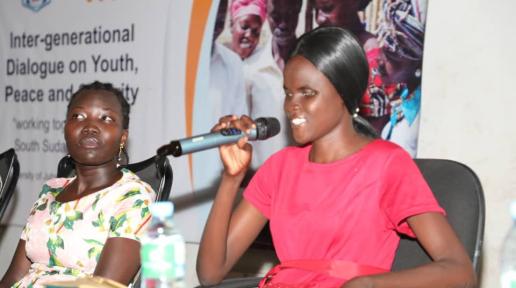 Precious Speaking at the intergenerational dialogue on Youth, Peace and Security as Anna Maneno looks on.